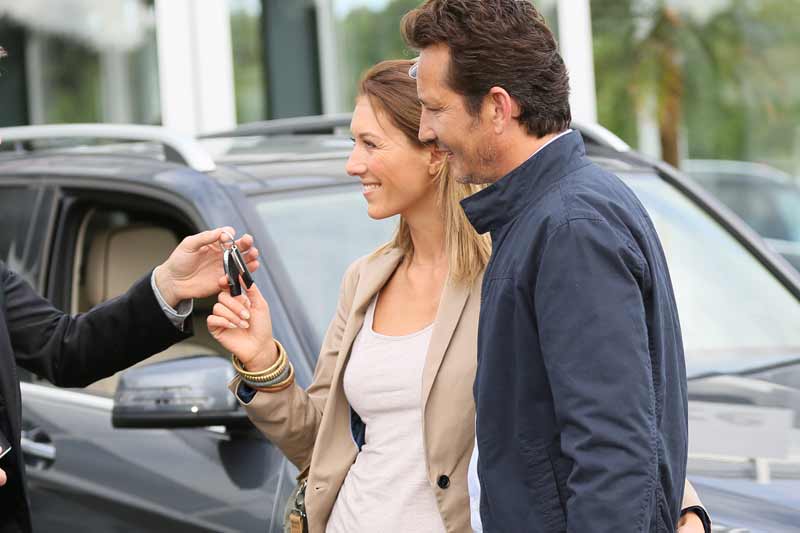 Customers receiving keys at the dealership
